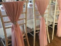 dusky-pink-chair-drapes-with-brooch